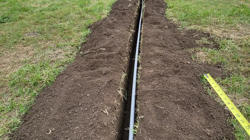 Trenched line for irrigation installation in lawn