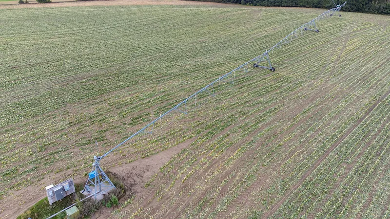 Aerial view of a center pivot sprinkler over green field